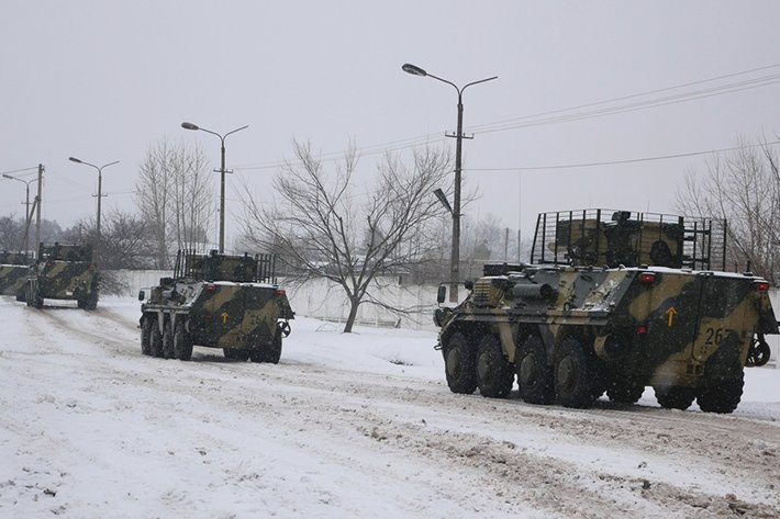 Kharkiv, Ukraine - January, 31, 2022: A column of armored personnel carriers rides on a winter road. Ukraine prepares to defend its country from Russian invasion